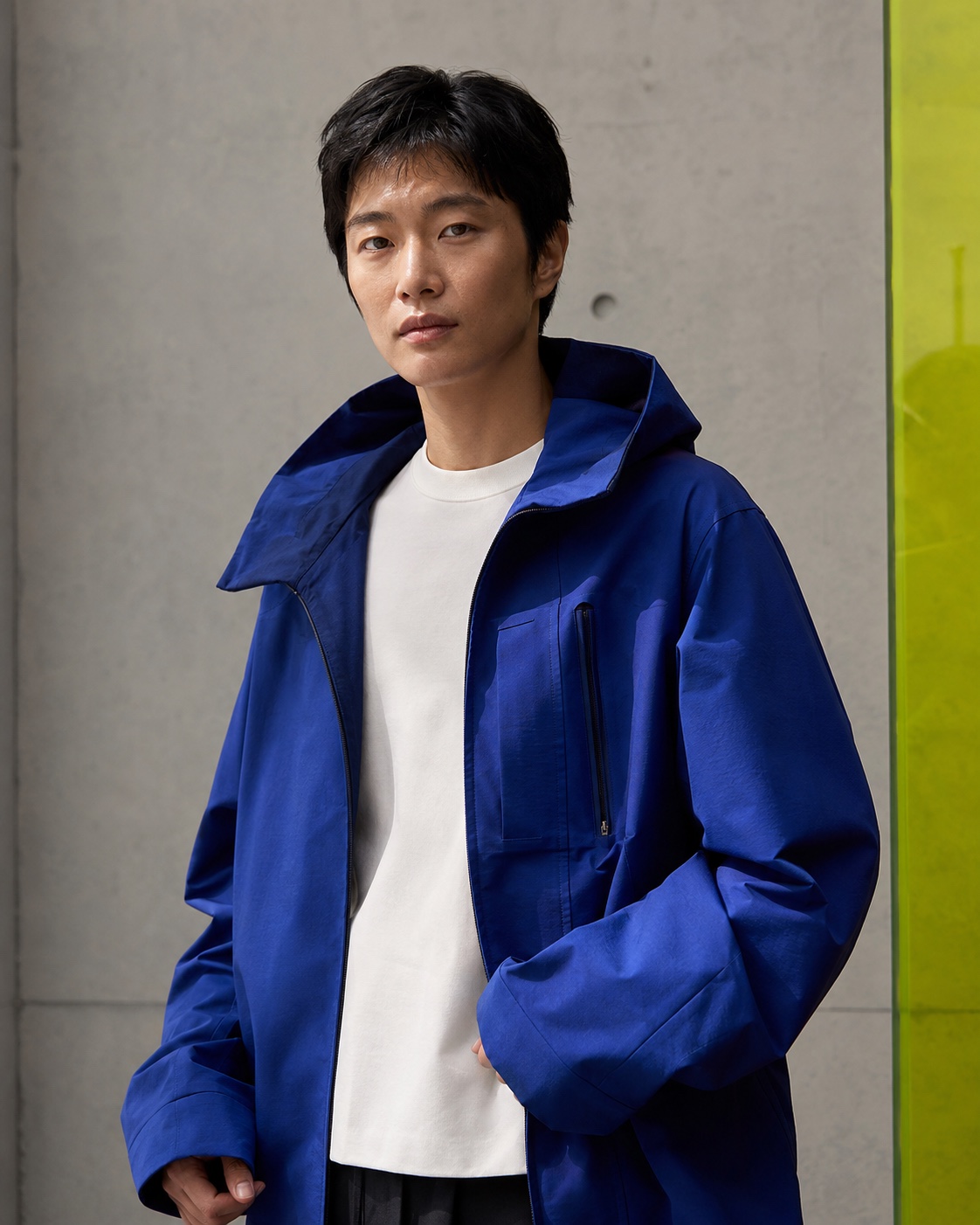 Editorial portrait in a cobalt technical jacket
